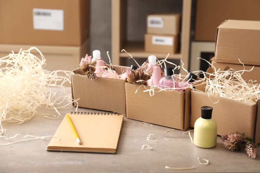 Beauty products in packed into cardboard, with a notepad in front